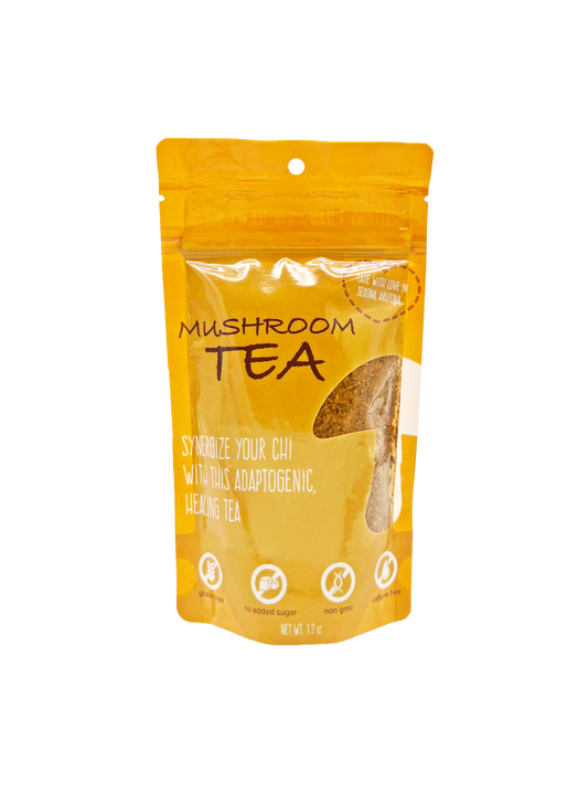 A stand-up pouch of Mushroom Tea herbal supplement on a plain white background. The packaging is a warm golden yellow-orange color with black text and a clear window showing the tea inside.